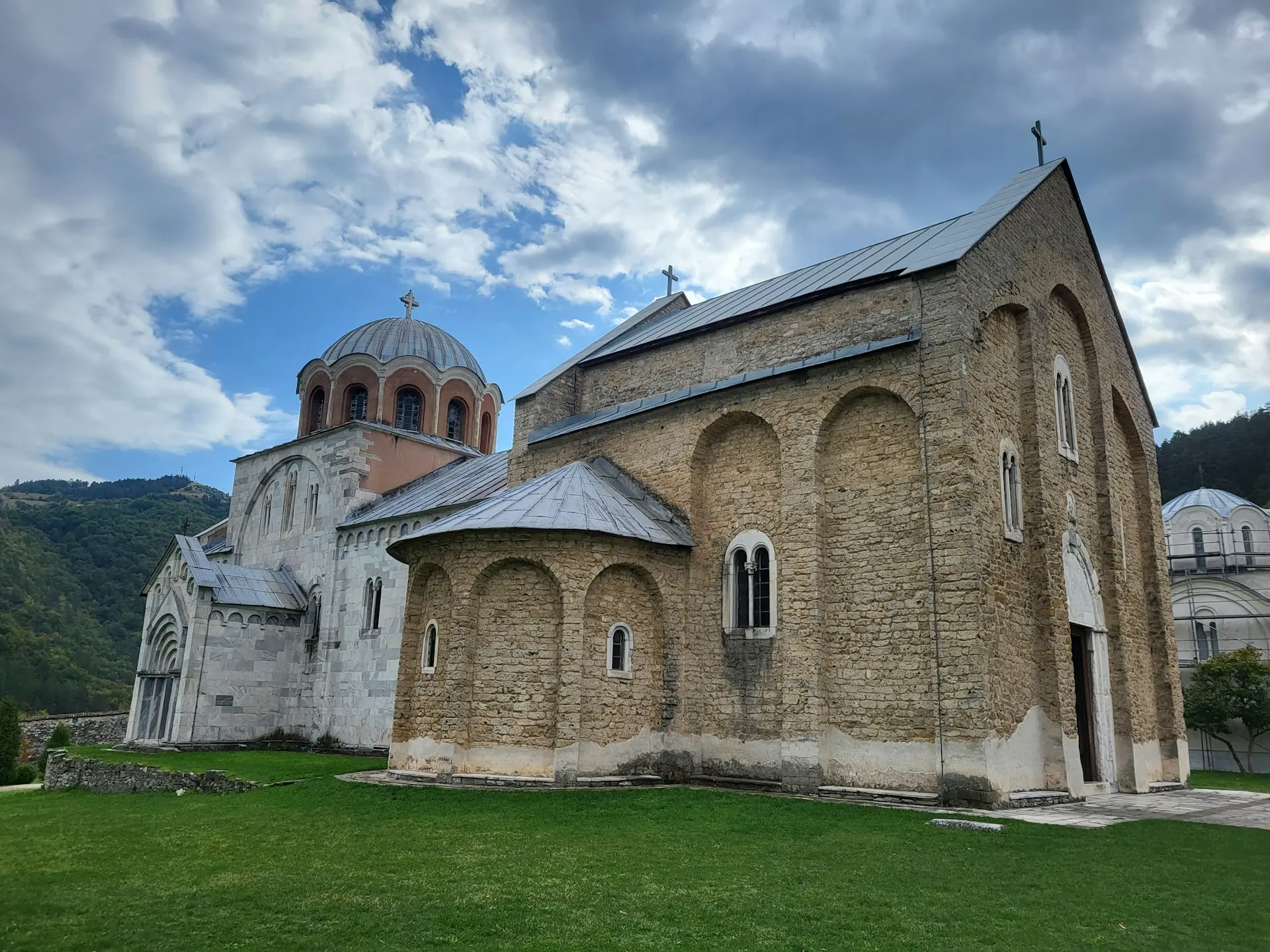 An old church with a steeple on a cloudy day